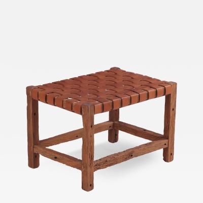 A rustic French wood bench with woven leather seat C 1930 