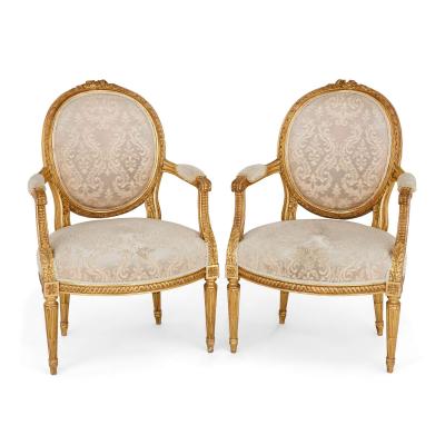 A set of four Louis XVI style giltwood fauteuils