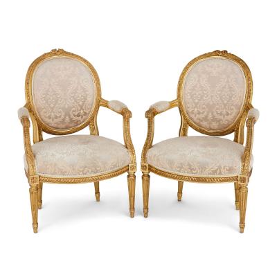 A set of four Louis XVI style giltwood fauteuils
