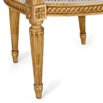 A set of four Louis XVI style giltwood fauteuils