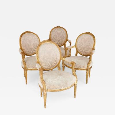 A set of four Louis XVI style giltwood fauteuils