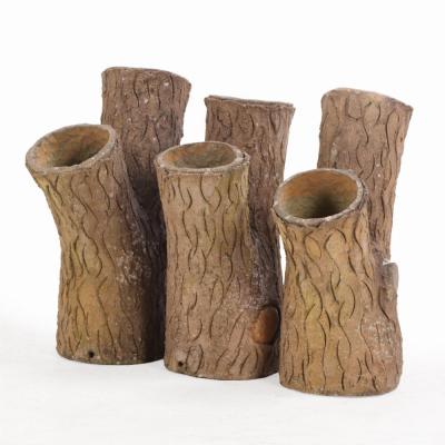 A set of three French tabletop faux bois cast stone planters C 1950 