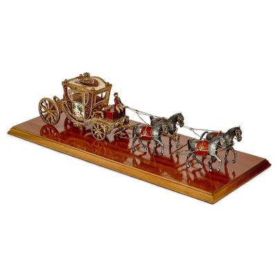 A silver gilt and enamel Austro Hungarian horse drawn carriage model