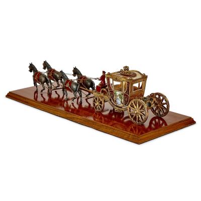 A silver gilt and enamel Austro Hungarian horse drawn carriage model