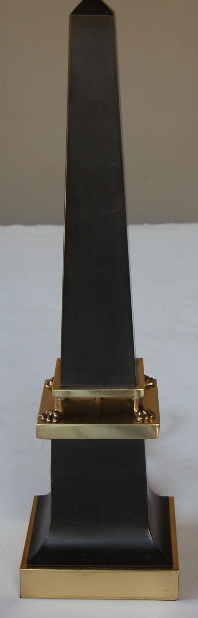 A sleek French 1940s black painted tole obelisk form lamp with brass mounts