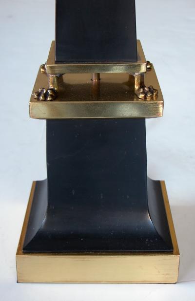 A sleek French 1940s black painted tole obelisk form lamp with brass mounts