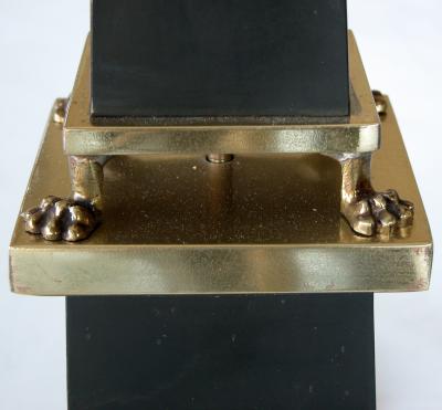 A sleek French 1940s black painted tole obelisk form lamp with brass mounts