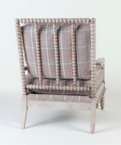 A spool framed chair with upholstered seat back cushion semi attached bolster