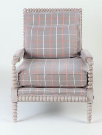 A spool framed chair with upholstered seat back cushion semi attached bolster