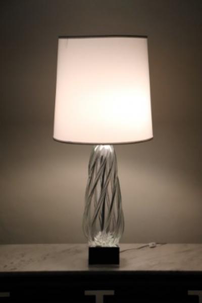 A tall swirl glass table lamp on chrome base