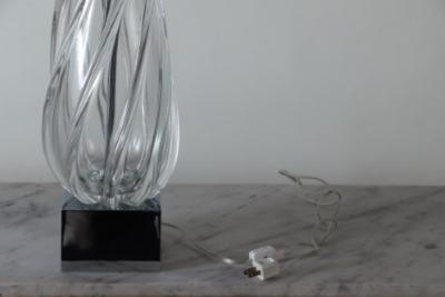 A tall swirl glass table lamp on chrome base