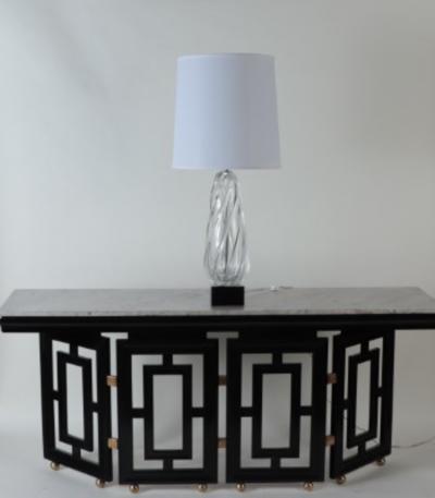 A tall swirl glass table lamp on chrome base