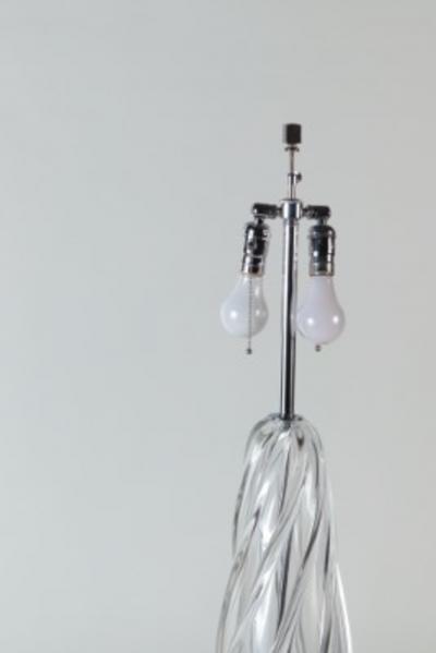 A tall swirl glass table lamp on chrome base