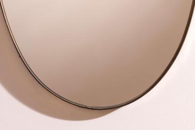 A wall mirror with brass frame Italy 1950s