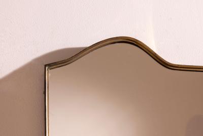 A wall mirror with brass frame Italy 1950s