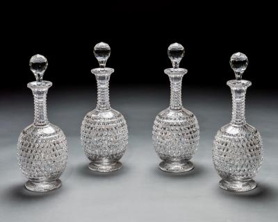 AN ELABORATELY CUT SUITE OF DECANTERS