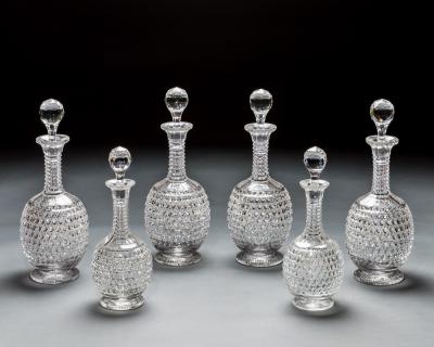 AN ELABORATELY CUT SUITE OF DECANTERS