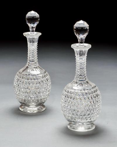 AN ELABORATELY CUT SUITE OF DECANTERS