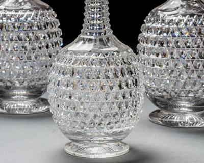 AN ELABORATELY CUT SUITE OF DECANTERS