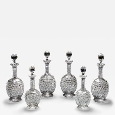 AN ELABORATELY CUT SUITE OF DECANTERS