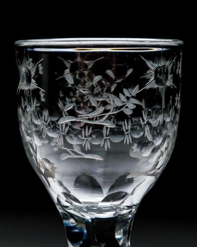 AN ELEGANT ENGRAVED FACET STEM WINE GLASS