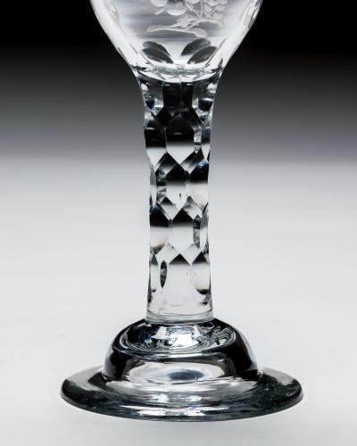 AN ELEGANT ENGRAVED FACET STEM WINE GLASS
