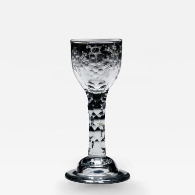 AN ELEGANT ENGRAVED FACET STEM WINE GLASS