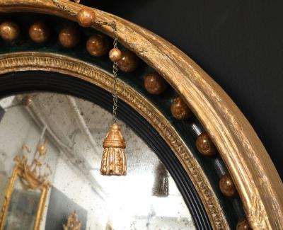 AN ENGLISH REGENCY GILTWOOD CONVEX MIRROR