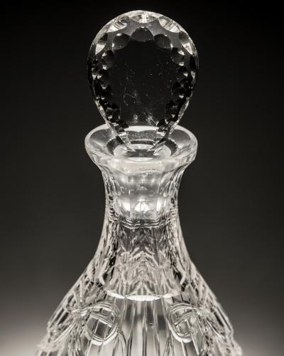 AN INTAGLIO CUT GLASS DECANTER