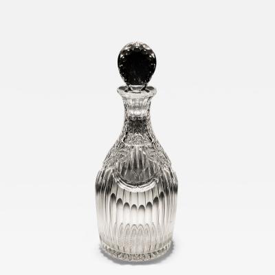 AN INTAGLIO CUT GLASS DECANTER