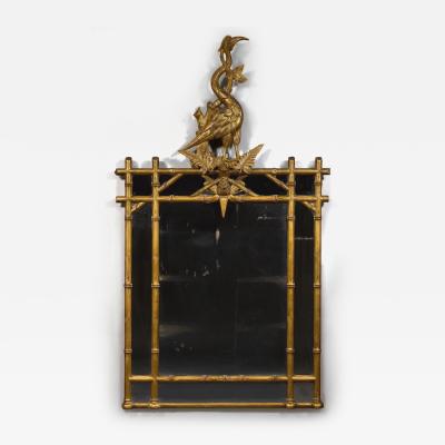 AN INTERESTING LATE REGENCY CARVED GILTWOOD MIRROR SURMOUNTED BY A CARVED HERON