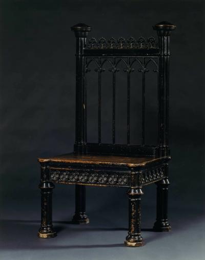 AN UNUSUAL MASSIVE EBONISED WOOD AND IRON CHAIR IN THE GOTHIC TASTE