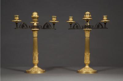 AN UNUSUAL PAIR OF GILT AND PATINATED BRONZE FOUR LIGHT NEOCLASSICAL CANDELABRA