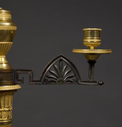 AN UNUSUAL PAIR OF GILT AND PATINATED BRONZE FOUR LIGHT NEOCLASSICAL CANDELABRA