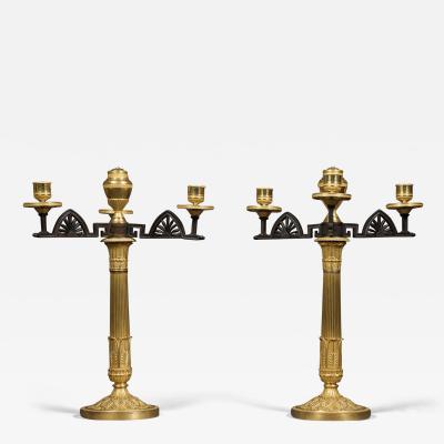 AN UNUSUAL PAIR OF GILT AND PATINATED BRONZE FOUR LIGHT NEOCLASSICAL CANDELABRA