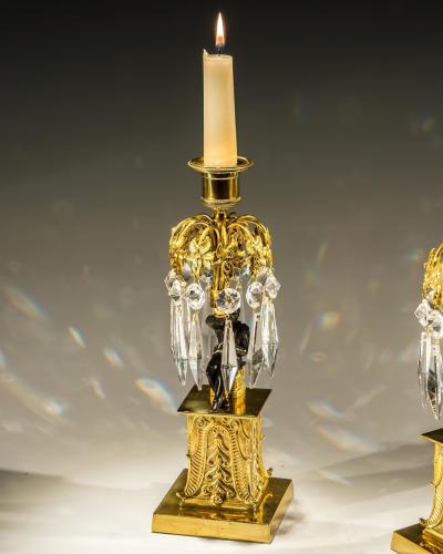 AN UNUSUAL PAIR OF GILT BRONZE MILITARY FIGURE CANDLESTICKS