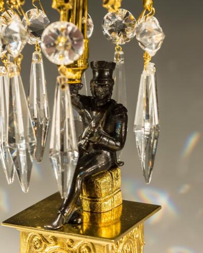 AN UNUSUAL PAIR OF GILT BRONZE MILITARY FIGURE CANDLESTICKS