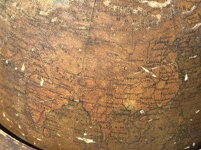 ANTIQUE GLOBE IN DECORATIVE IRON STAND WITH TRIPOD BASE