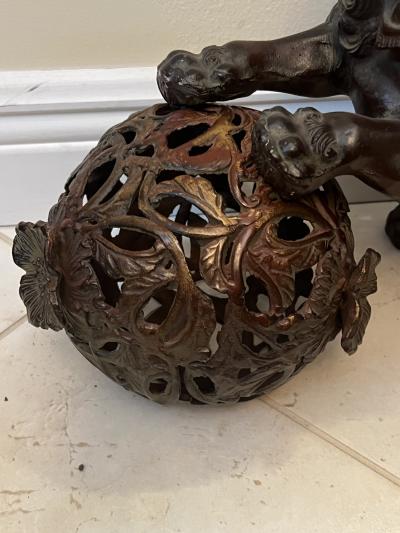 ANTIQUE PATINATED IRON FOO DOG WITH GILT BALL WITH FLOWERS SCULPTURE