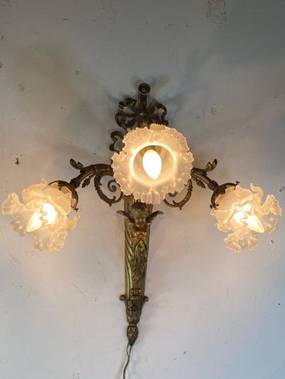 ART NOUVEAU FRENCH BRONZE CUPID SCONCE WITH THREE FANCY GLASS FLOWER SHADES