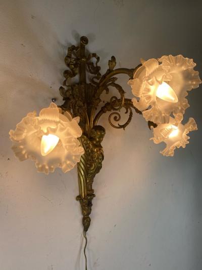 ART NOUVEAU FRENCH BRONZE CUPID SCONCE WITH THREE FANCY GLASS FLOWER SHADES