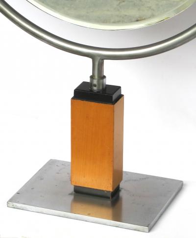 An American art deco steel dressing mirror raised on a maplewood base