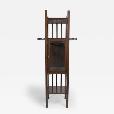 An Anglo Japanese style Mahogany side cabinet of slender form with brass sabots 