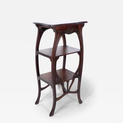 An Art Nouveau Mahogany Three Tier Plant Stand with Shallow Floral Carving