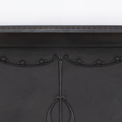 An Arts Crafts Art Nouveau Cast Iron Fireplace with Stylized Floral Details
