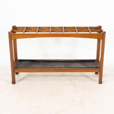 An Arts Crafts Oak Stick Umbrella Stand with Fourteen Sections