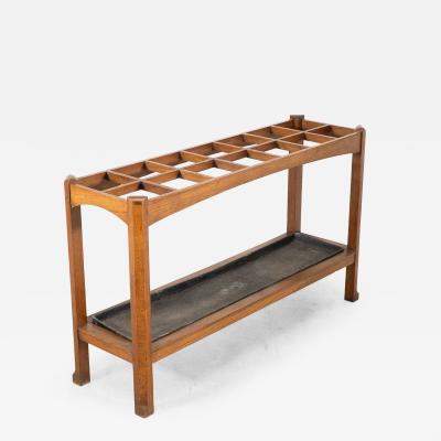 An Arts Crafts Oak Stick Umbrella Stand with Fourteen Sections