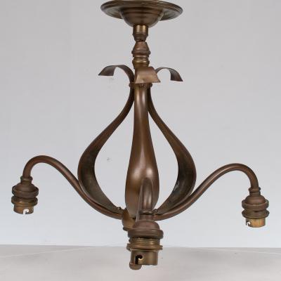 An Arts Crafts Three Branch Brass Ceiling Light with Stylized Leaf Detail