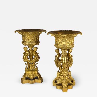 An Elaborate Pair of Figural Gilt Bronze Tazzas Supported by Three Cherubs