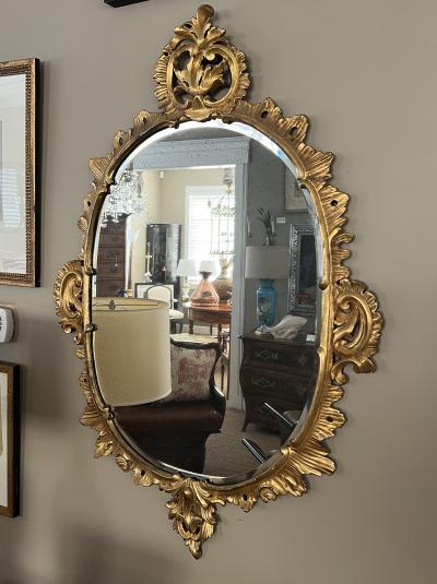 An Elegantly Carved French Louis XV Rococo Giltwood Oval Mirror
